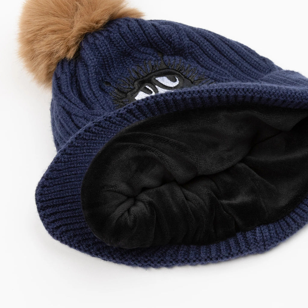 3. Close-up of navy blue Moomin Stinky beanie showing soft black fleece lining and brown pom-pom