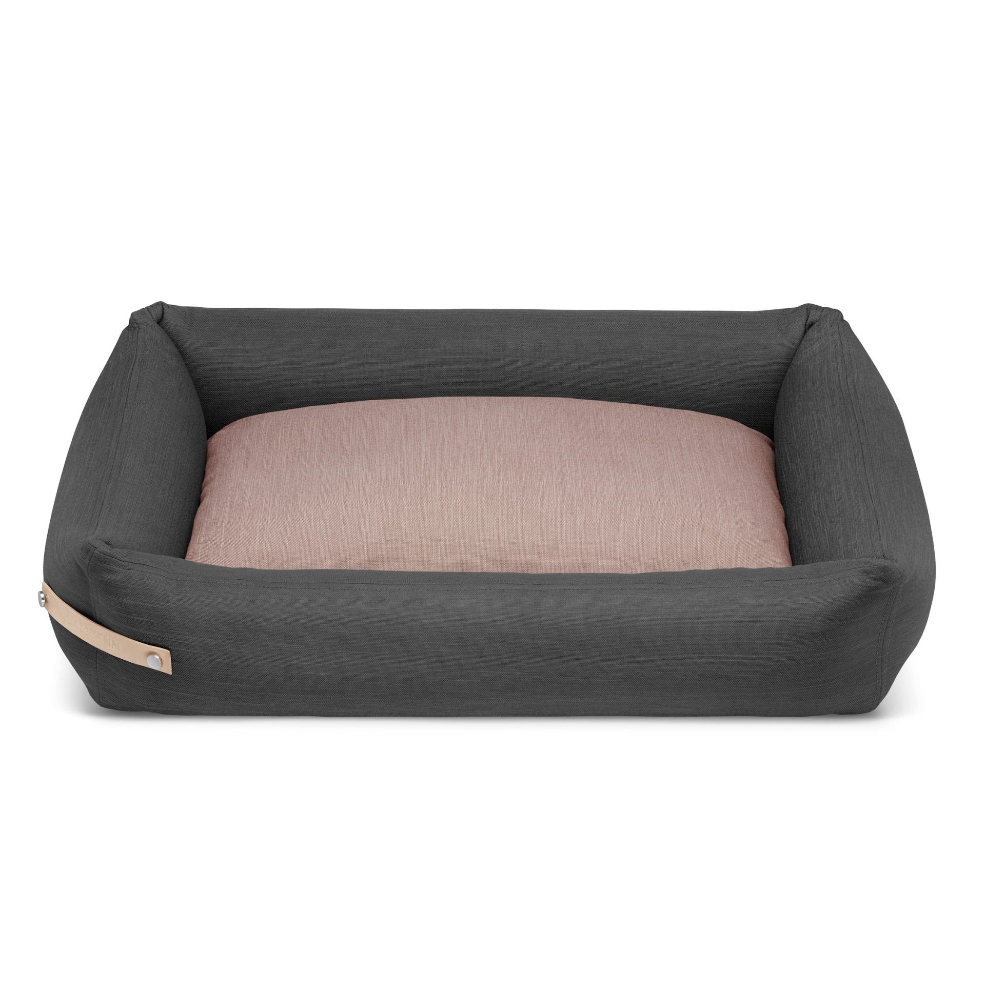 2. Grey and pink Stokke dog bed by Labbvenn with leather belt detail, shown in studio setting highlighting spacious design and removable cover