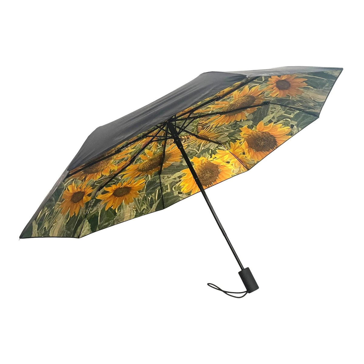 2. Sunflower umbrella with vibrant sunflower print and black exterior shown open in studio setting