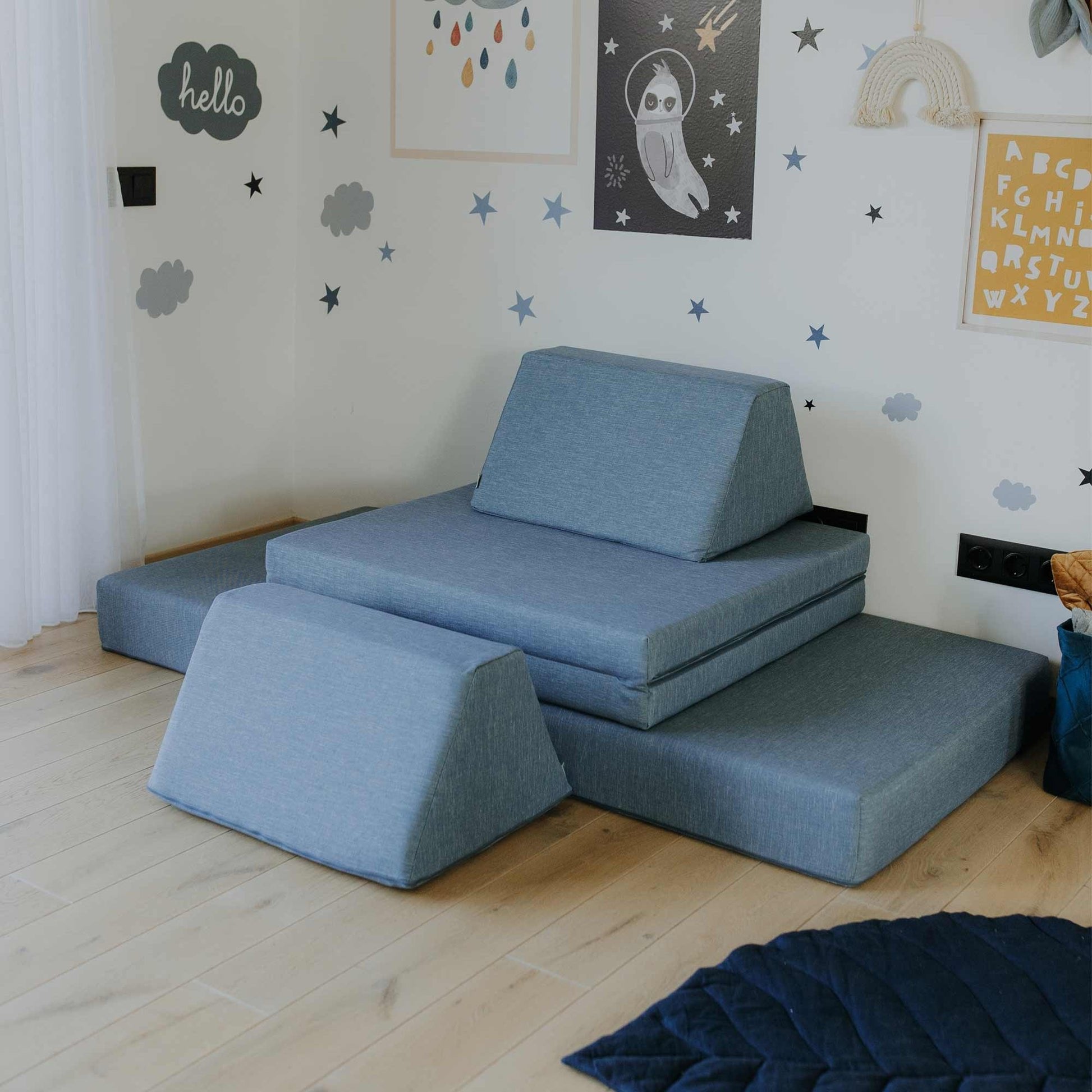 9. Turquoise Monboxy play mattress set arranged with trapezoidal pillows in a star-themed children's room