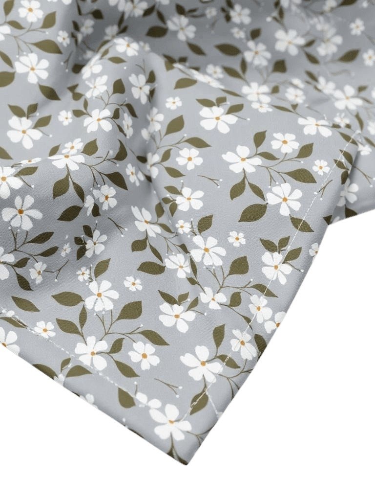 2. Detail shot of Flowery Stories bandana highlighting white blossom pattern on grey fabric, emphasizing texture and floral design