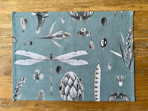 2. Flat lay of Hortensias Home Seeds Aqua placemat showcasing botanical print on 100% cotton fabric