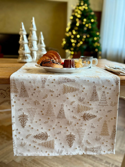 3. Golden Forest table runner on dining table with pastries, coffee, and Christmas tree in background, showcasing holiday decor