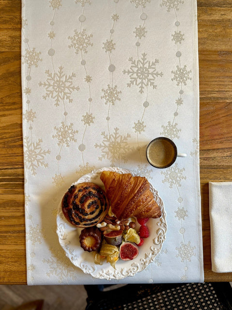 2. Top view of Golden Snowfall table runner with pastries and coffee on wooden table