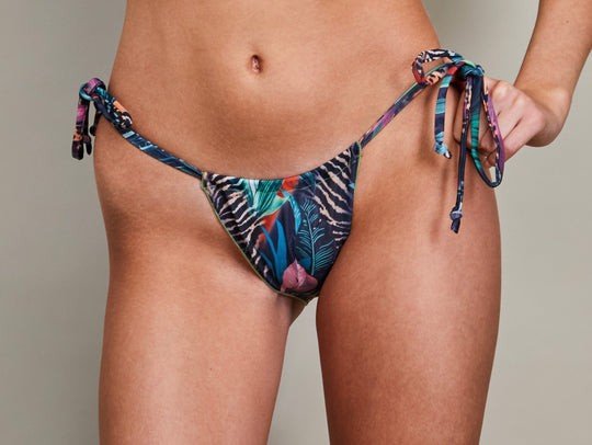3. Close-up of string bikini bottoms in tropical print by SWIMSARA