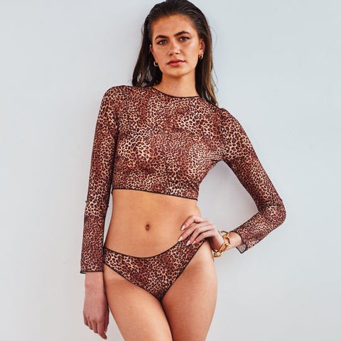 1. Women's tan-through long sleeve bikini set in mini feline print by SWIMSARA, worn by model in studio
