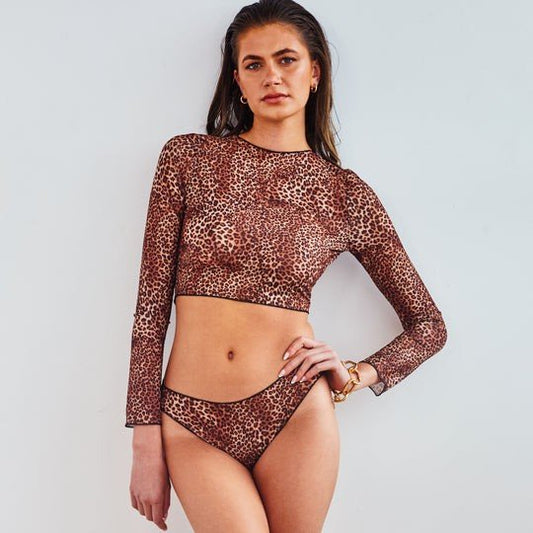 1. Women's tan-through long sleeve bikini set in mini feline print by SWIMSARA, worn by model in studio