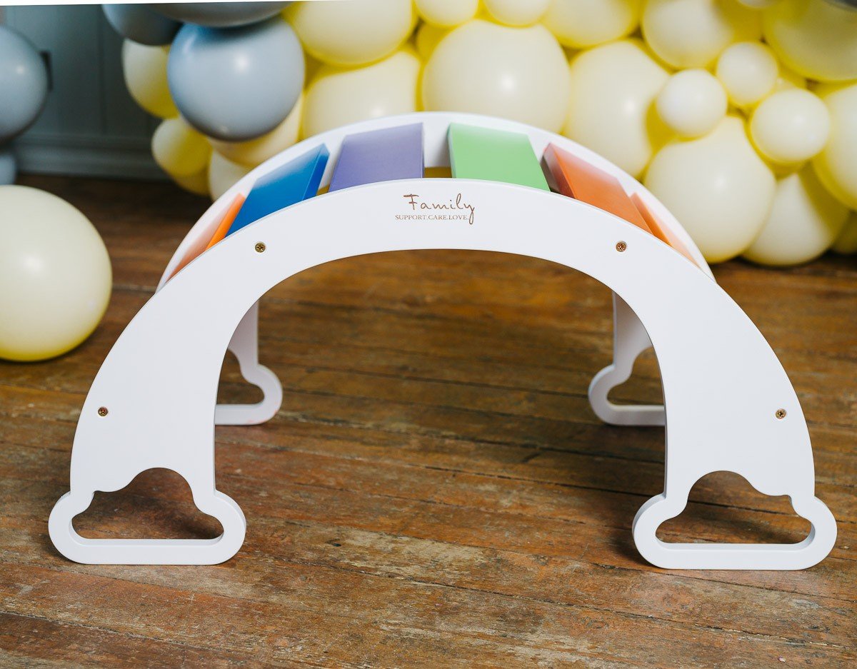 2. Front view of colorful rainbow climber with balloons in background