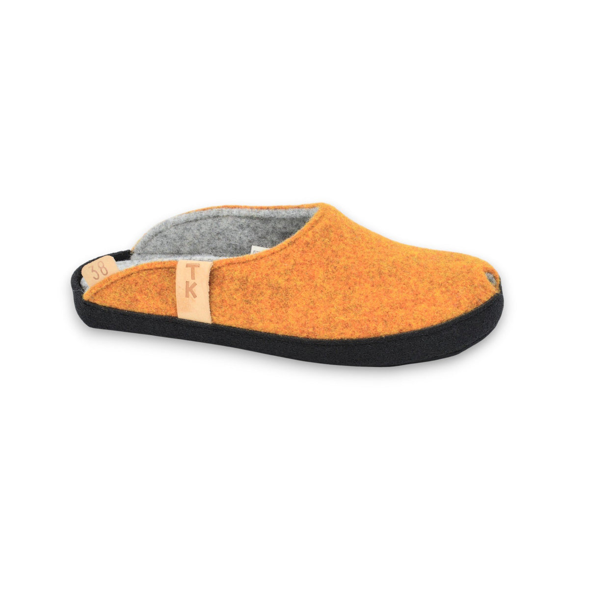 1. Single turmeric-colored TOKU Brussels slipper made from lambswool felt with black microfibre sole, shown in side view on white background