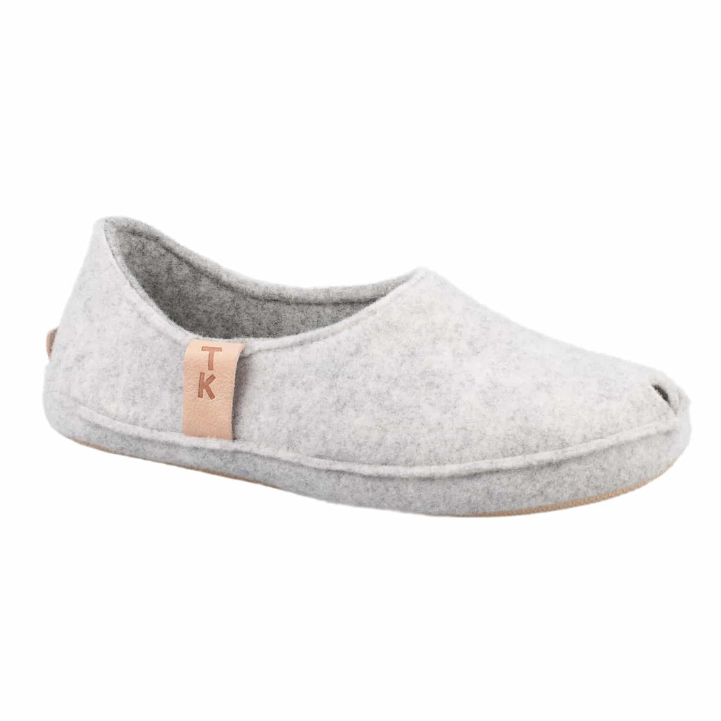 3. Close-up of single TOKU Budapest slipper in white, highlighting natural lambswool felt and TK branding