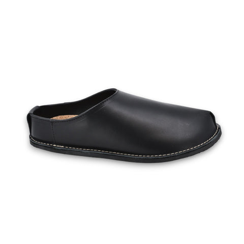 2. Unisex black slip-on shoe with natural vegetable-tanned leather upper and EVA outsole, shown in studio setting
