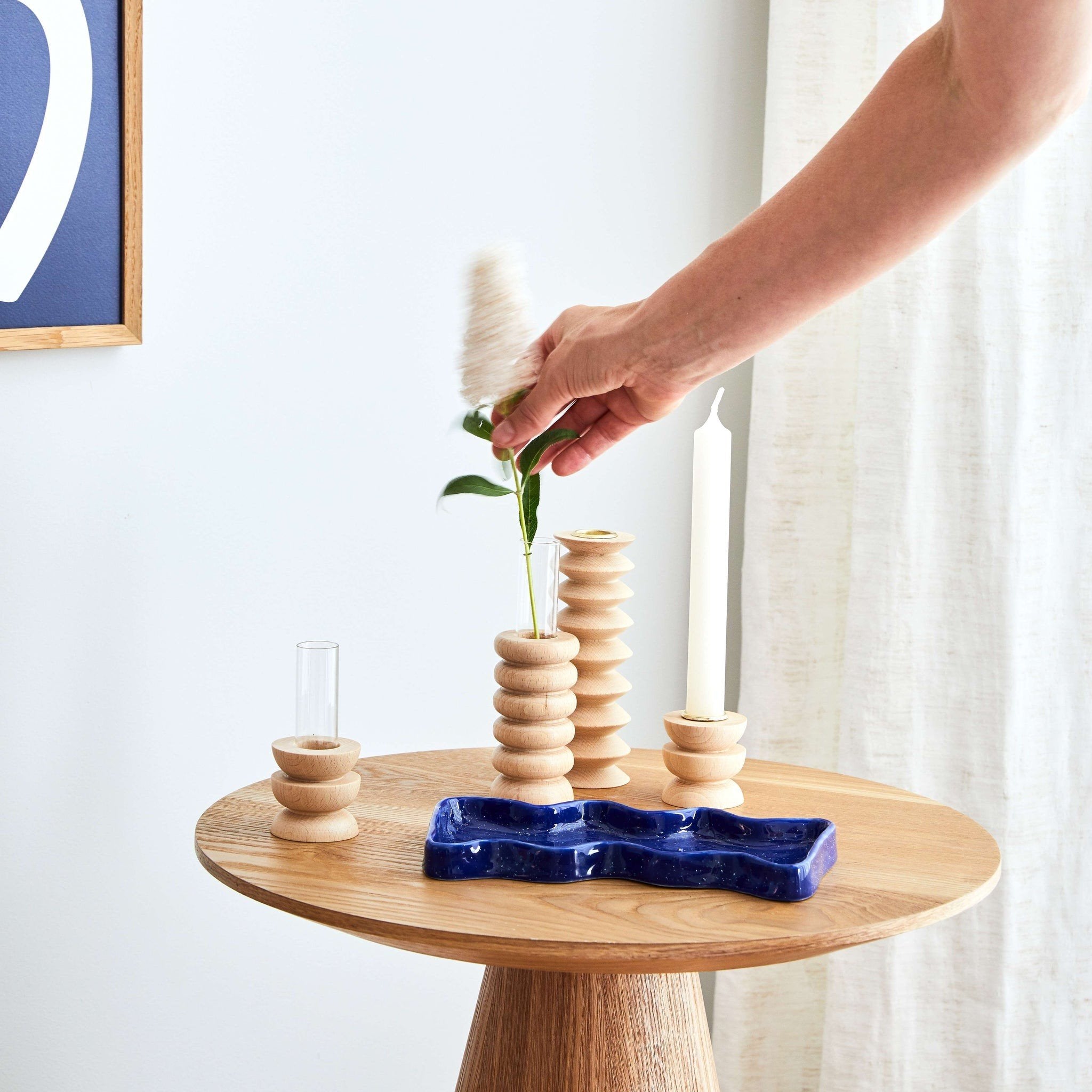 7. Close-up of Totem Wooden Vase - Medium Nº 1 by 5mm Paper on a table with hand arranging flowers