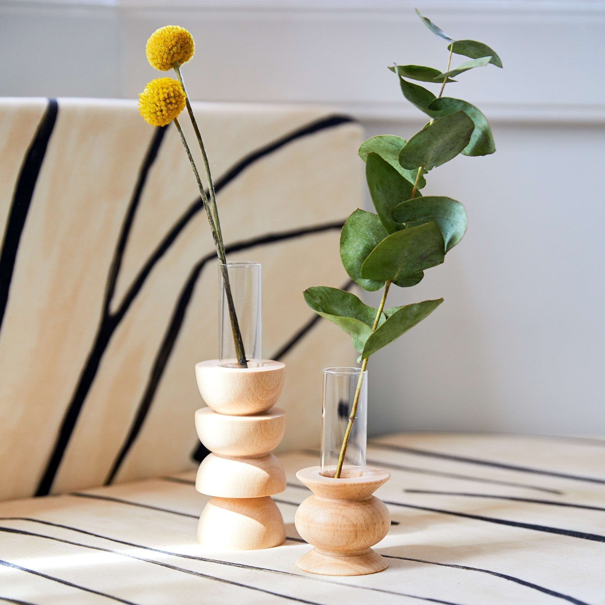 2. Totem Wooden Vase - Short Nº 5 by 5mm Paper styled with flowers on a patterned surface, highlighting its elegant beech wood and glass design