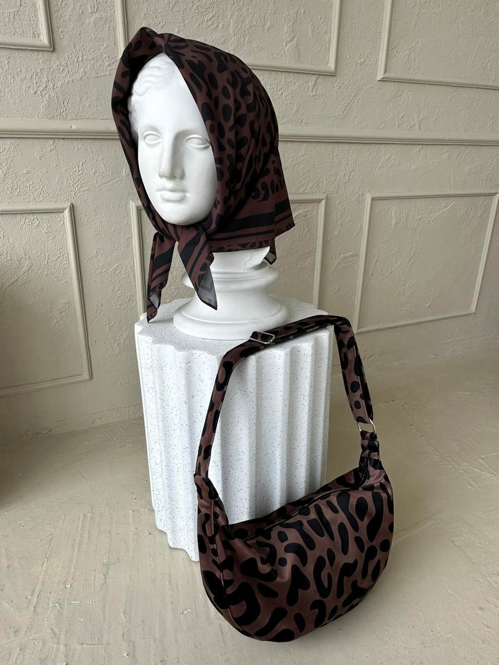 8. Garbanota Classic Leopard Hobo Bag on display with scarf, showcasing leopard print and craftsmanship