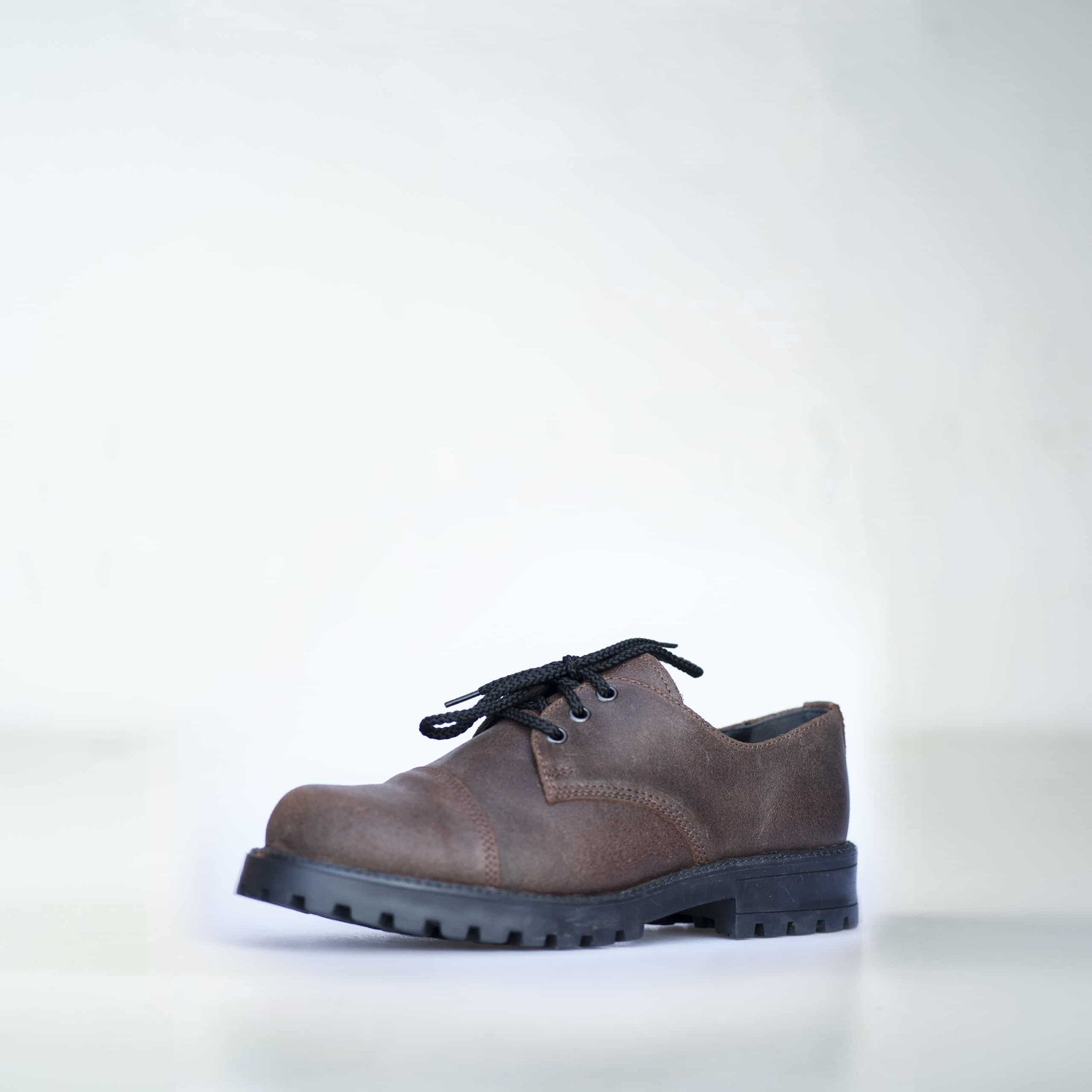 1. Unisex dark brown leather Samelin Widgets shoe with black laces, shown in studio setting