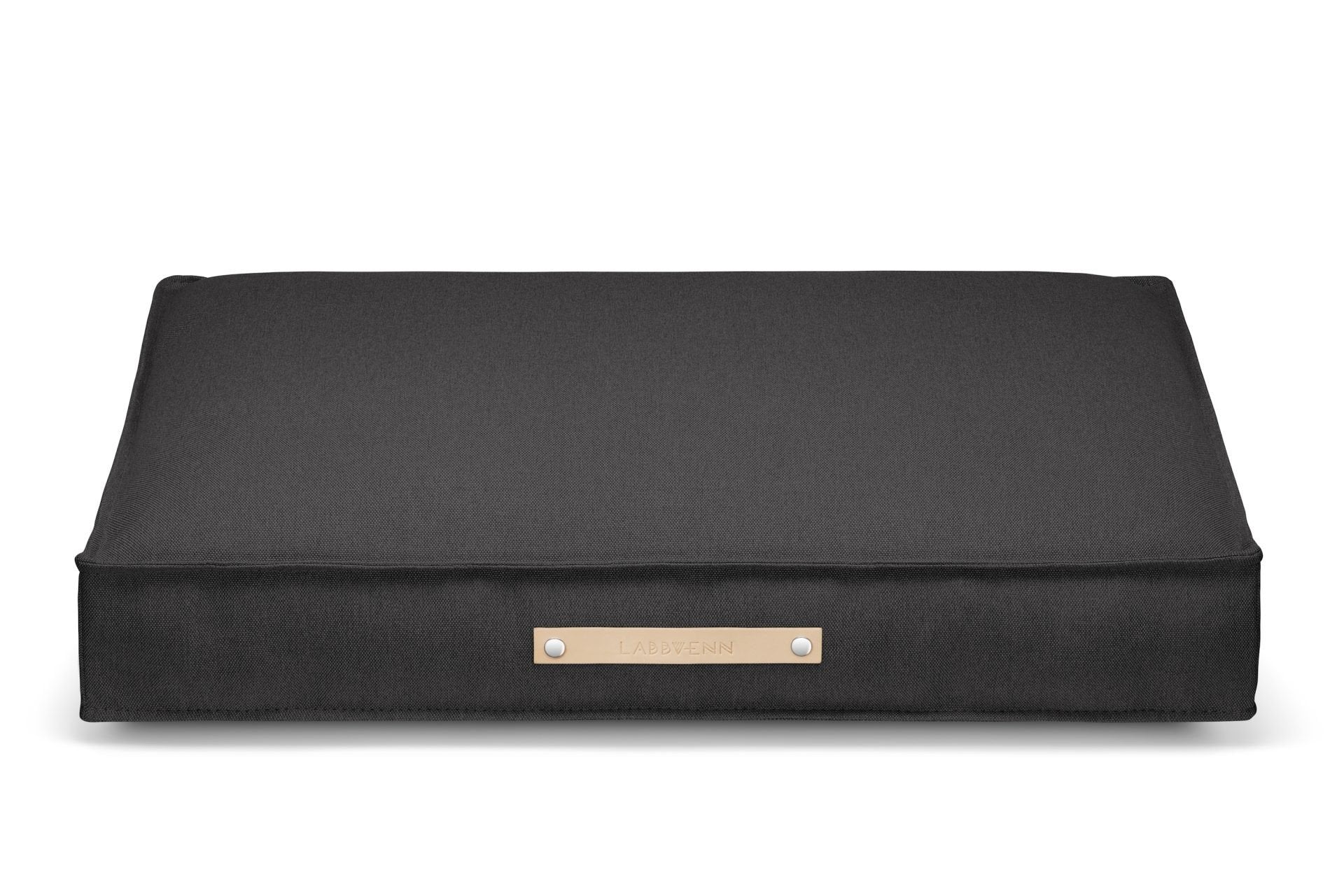 2. Labbvenn Töve cushion in anthracite with leather handle, shown in studio setting highlighting minimalist design