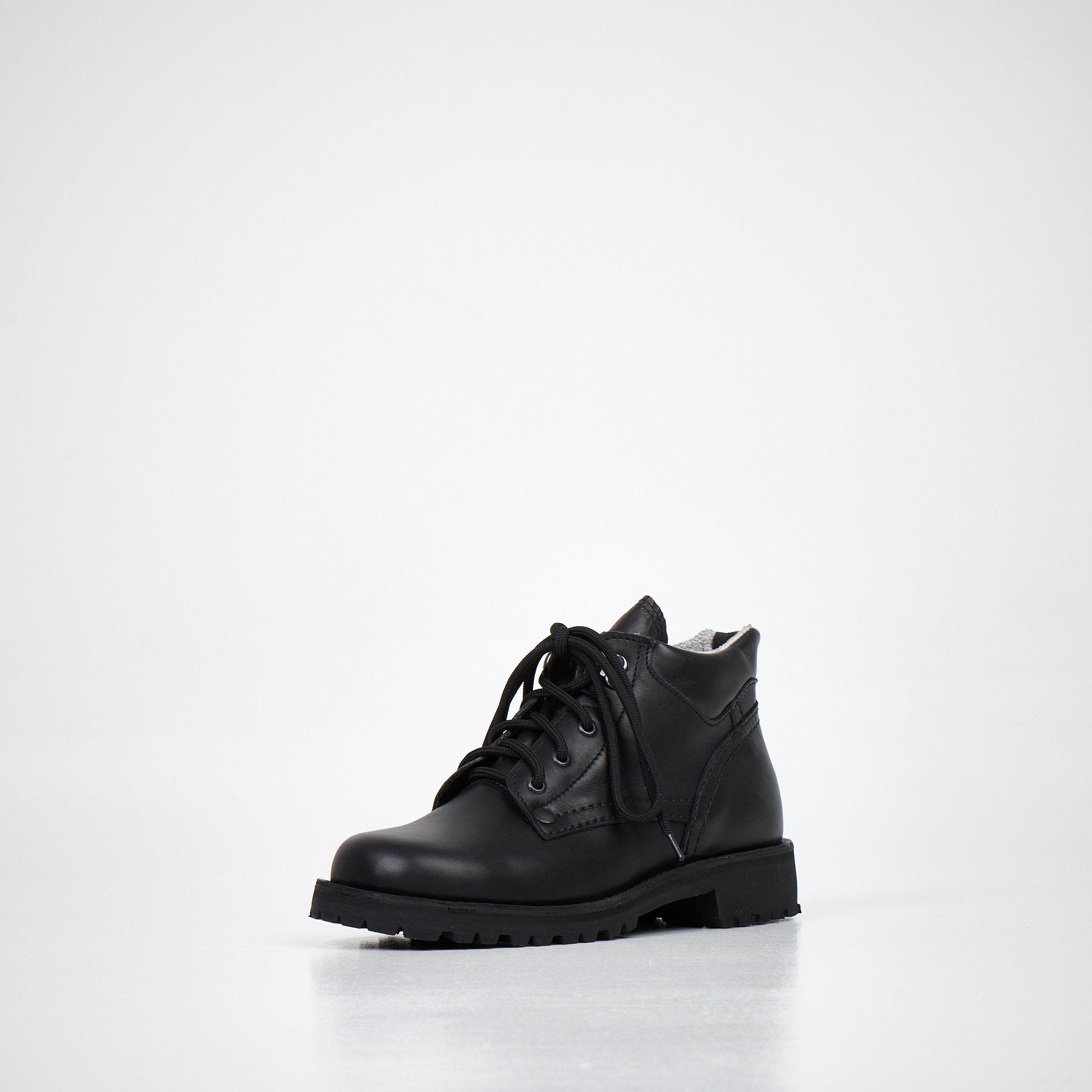 2. Back view of AIPI Handmade Ankle Boots in black leather, highlighting the heel and sole design