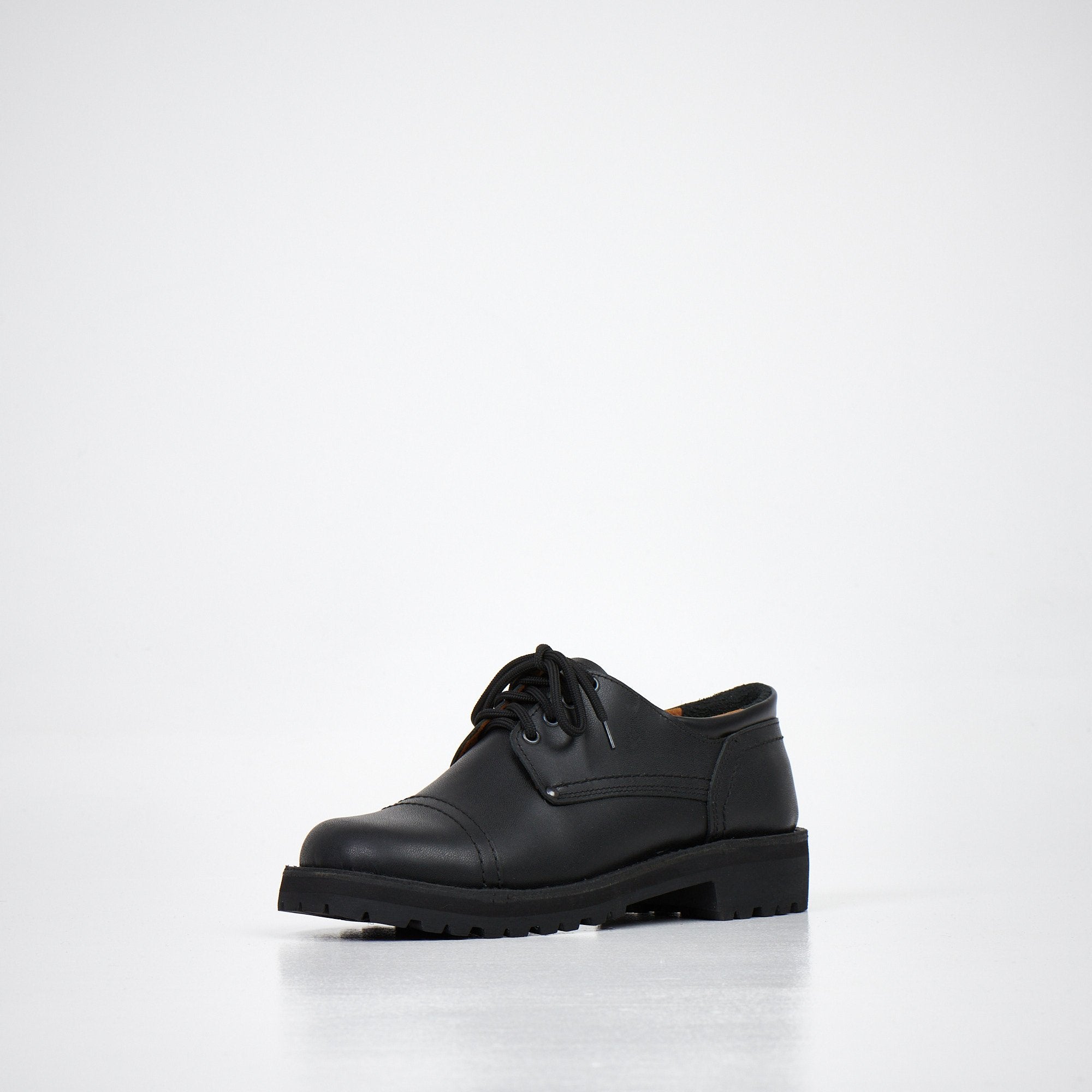 2. Unisex AIPI handmade leather shoes in black, angled front view highlighting natural leather upper and lace-up design, studio setting