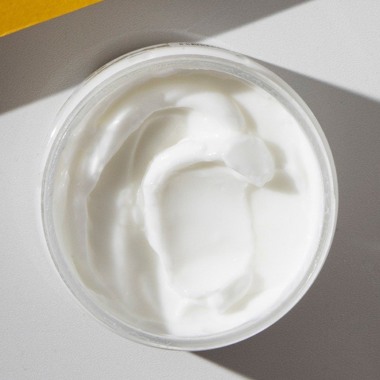 2. Close-up of Vegan Fox Grapefruit Body Cream showing creamy texture in an open jar