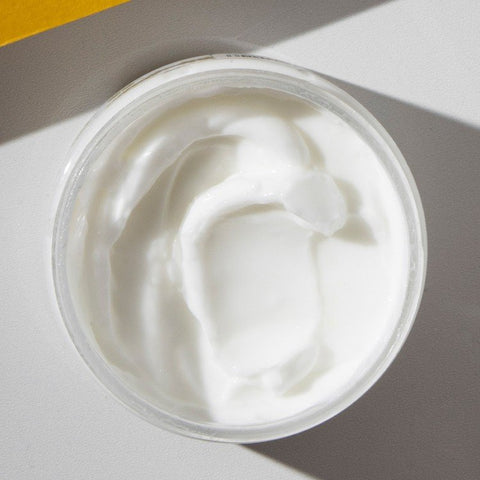 2. Close-up of Vegan Fox Grapefruit Body Cream showing creamy texture in an open jar