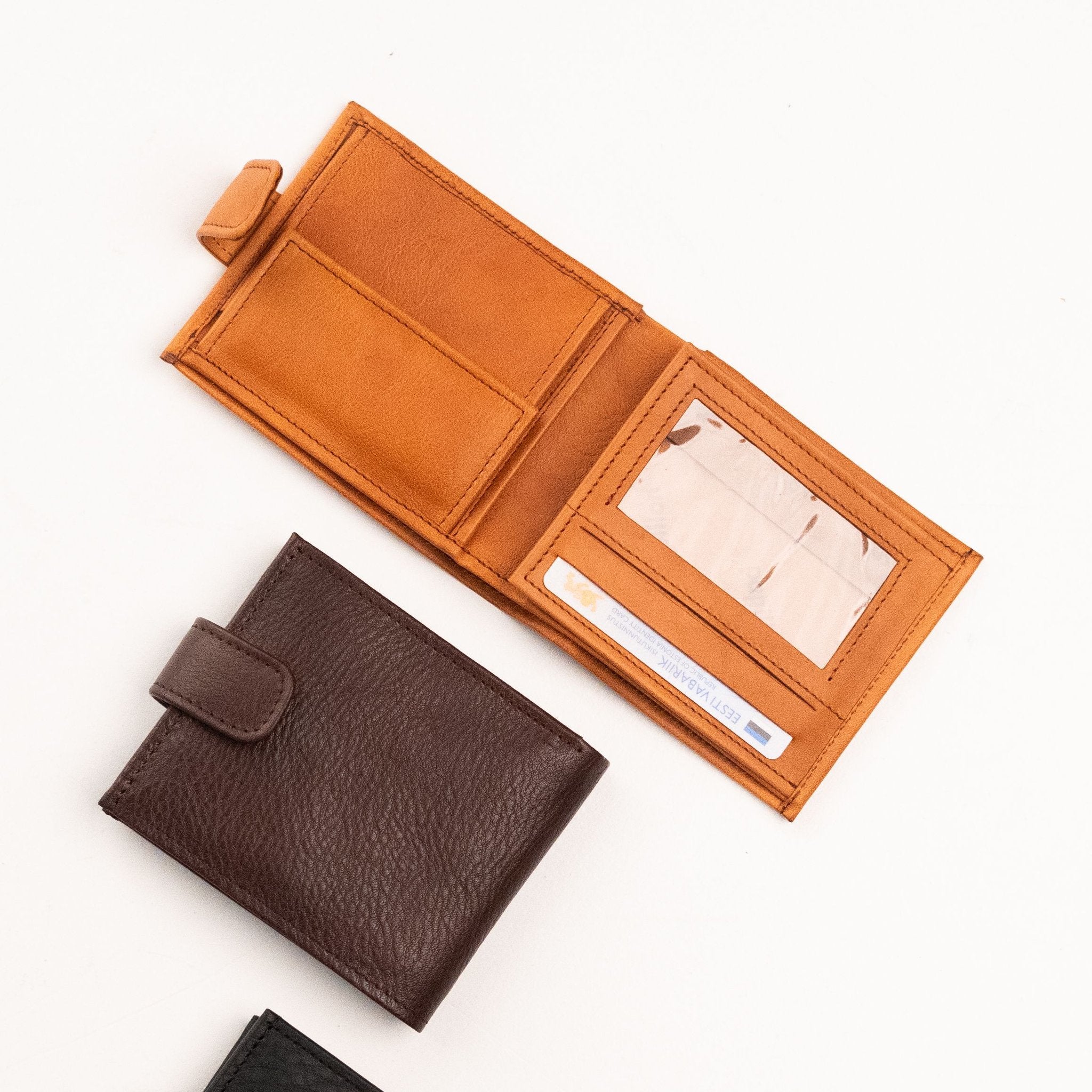 2. Flat lay of men's leather wallets in brown and tan by Papillon, showing interior card slots and ID window