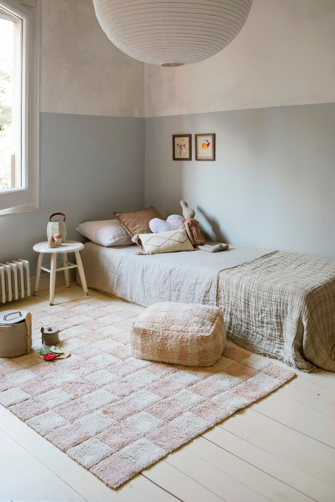 1. Bedroom with Lorena Canals rose and white checkerboard rug and matching pouf on light wooden floor