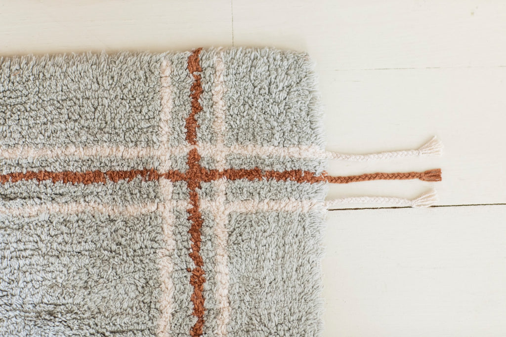 3. Close-up of Lorena Canals rug corner in Blue Sage, highlighting tufted cotton texture and braided edge detail