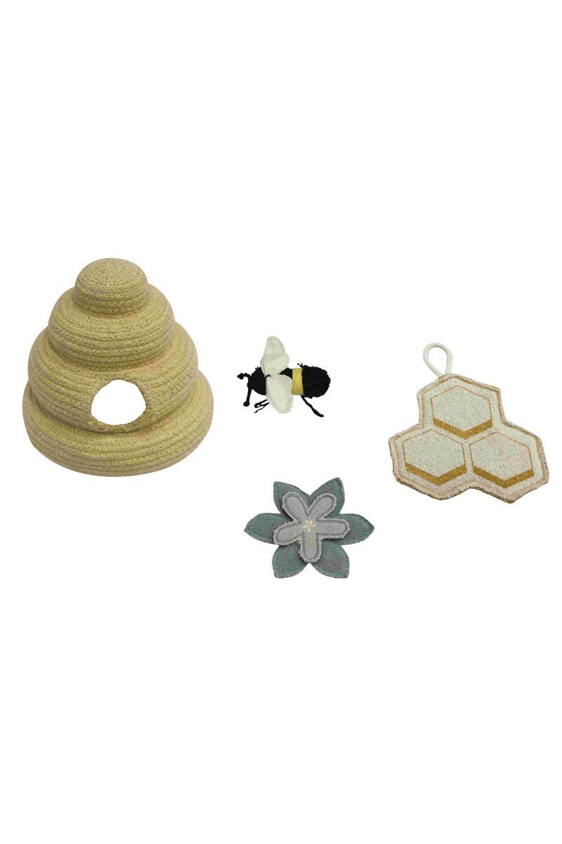 7. Close-up of four handmade textile accessories including a honey-colored beehive, bee, blue sage flower, and printed honeycomb