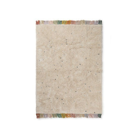 2. Studio shot of Lorena Canals Stardust washable rug in natural color with dark dots and multicolored fringes, 120 x 160 cm