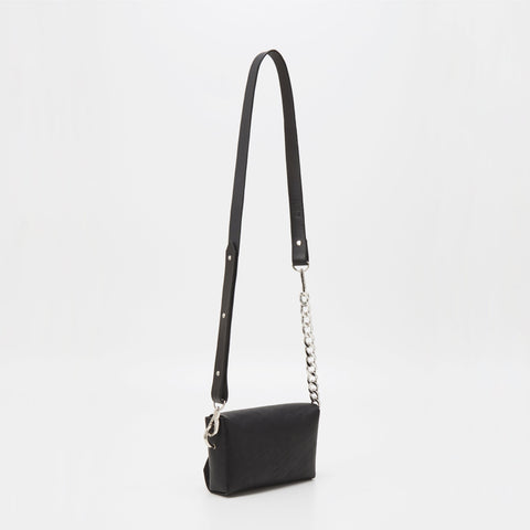 4. Studio image of handmade black leather envelope bag by Daz Studio with adjustable strap and chain detail