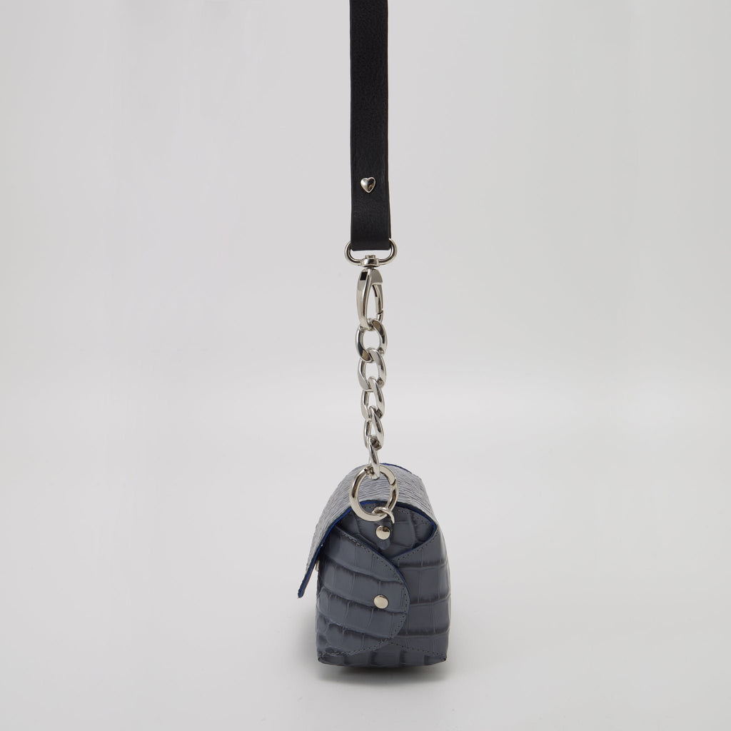 4. Studio shot of Daz Studio's handmade grey and blue leather shoulder bag, featuring adjustable strap and silver-toned hardware