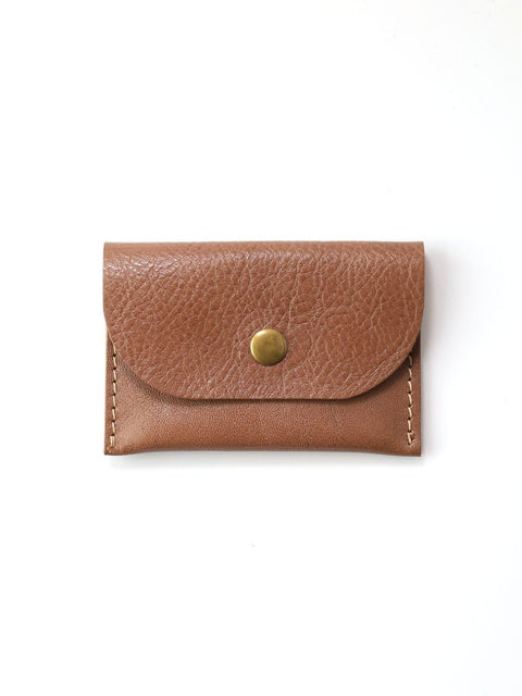 1. Studio shot of Toks Visoks WEEKEND wallet in cappuccino leather with brass button closure on white background