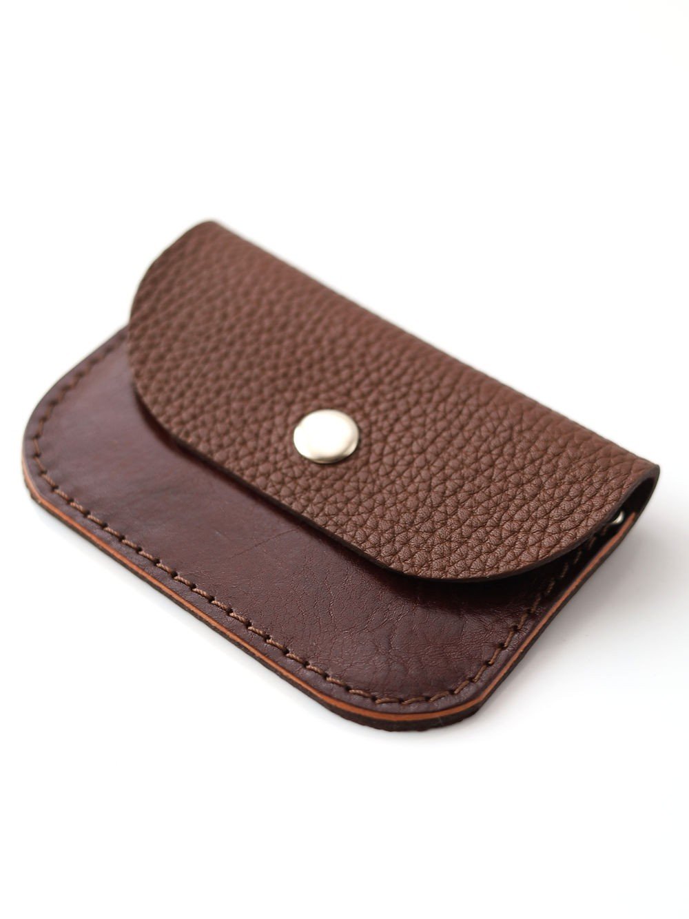1. Studio shot of Toks Visoks handmade leather wallet in brown and chestnut with textured flap and metal snap closure