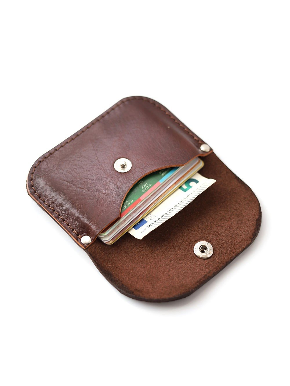 3. Open Toks Visoks leather wallet in brown and chestnut showing card slots with cards inside