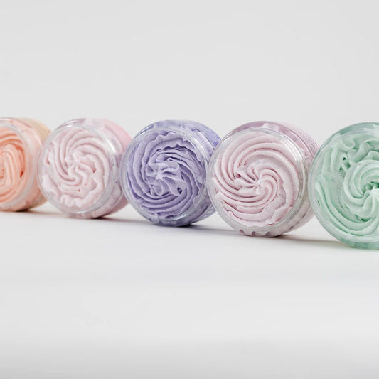 2. Assorted North Beauty whipped sugar body scrubs in various colors, shown from top view in studio setting