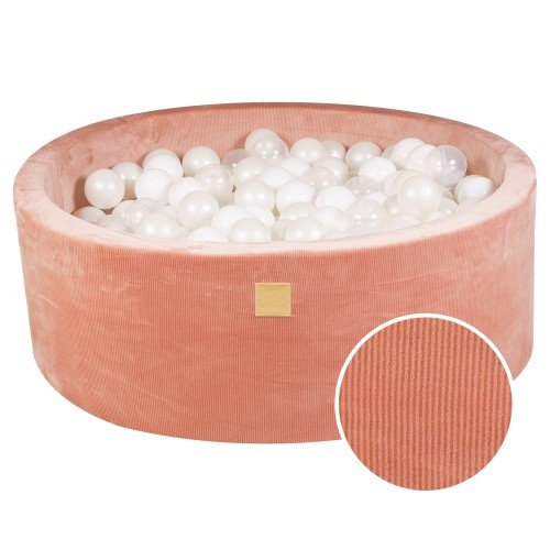 1. Apricot velvet round ball pit filled with translucent and white balls, featuring a soft, hypoallergenic foam structure and a machine washable cover, ideal for children's sensory play and motor skill development.