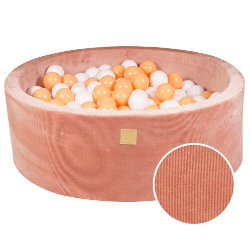 1. Apricot velvet round ball pit filled with white and orange balls, featuring soft hypoallergenic foam and machine washable cover, ideal for children's sensory play and motor skill development