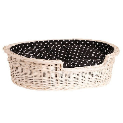 2. Angled view of whitewashed wicker dog bed with black polka dot cushion, showcasing spacious interior