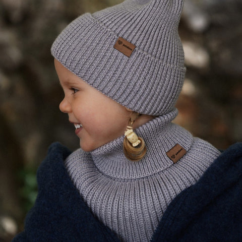 4. Child wearing grey merino wool tube scarf and hat by Patulove, smiling outdoors