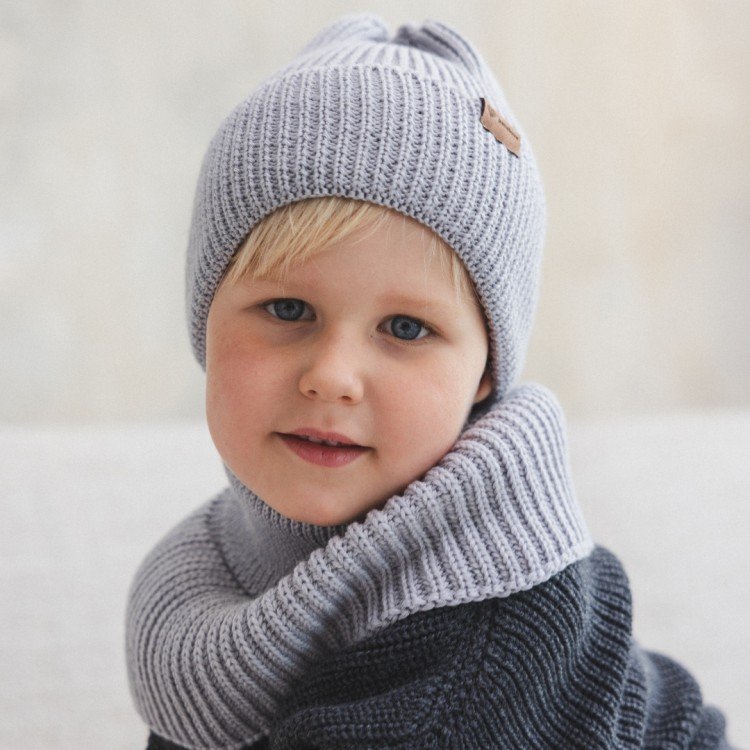 5. Child wearing grey merino wool tube scarf and hat, sitting indoors, looking at camera