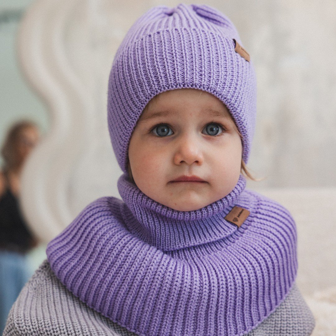 2. Child in lavender merino wool hat and matching neck warmer, front view, indoors