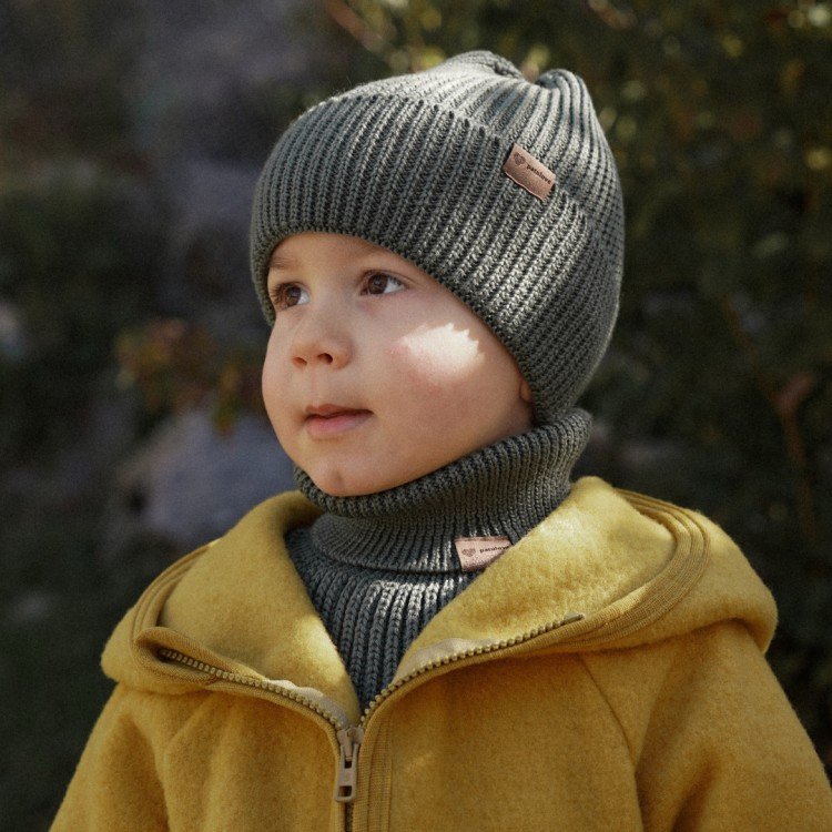 4. Child in olive merino wool hat and neck warmer by Patulove with yellow jacket outdoors