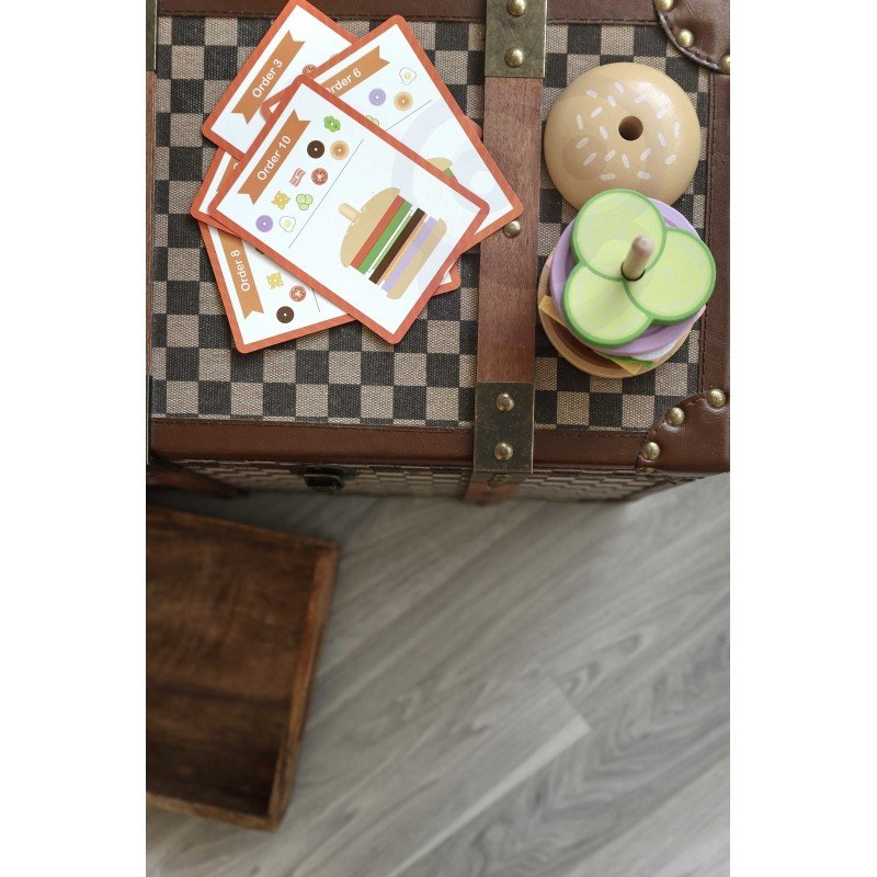 4. Wooden burger puzzle pieces and recipe cards on a checkered trunk, showcasing colorful ingredients