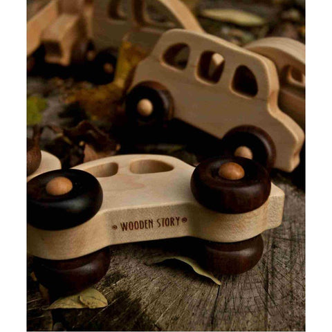 3. Close-up of Wooden Story toy cars on wooden surface, highlighting natural wood texture and brand logo
