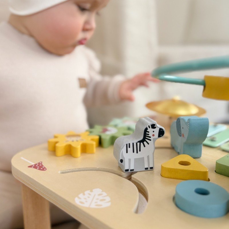 9. Toddler playing with zebra and elephant shapes on Woopie 5-in-1 activity table