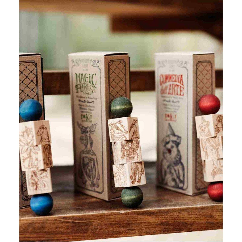 2. Three Commedia Dell'Arte wooden spinning puzzles in packaging with colorful ends on wooden shelf