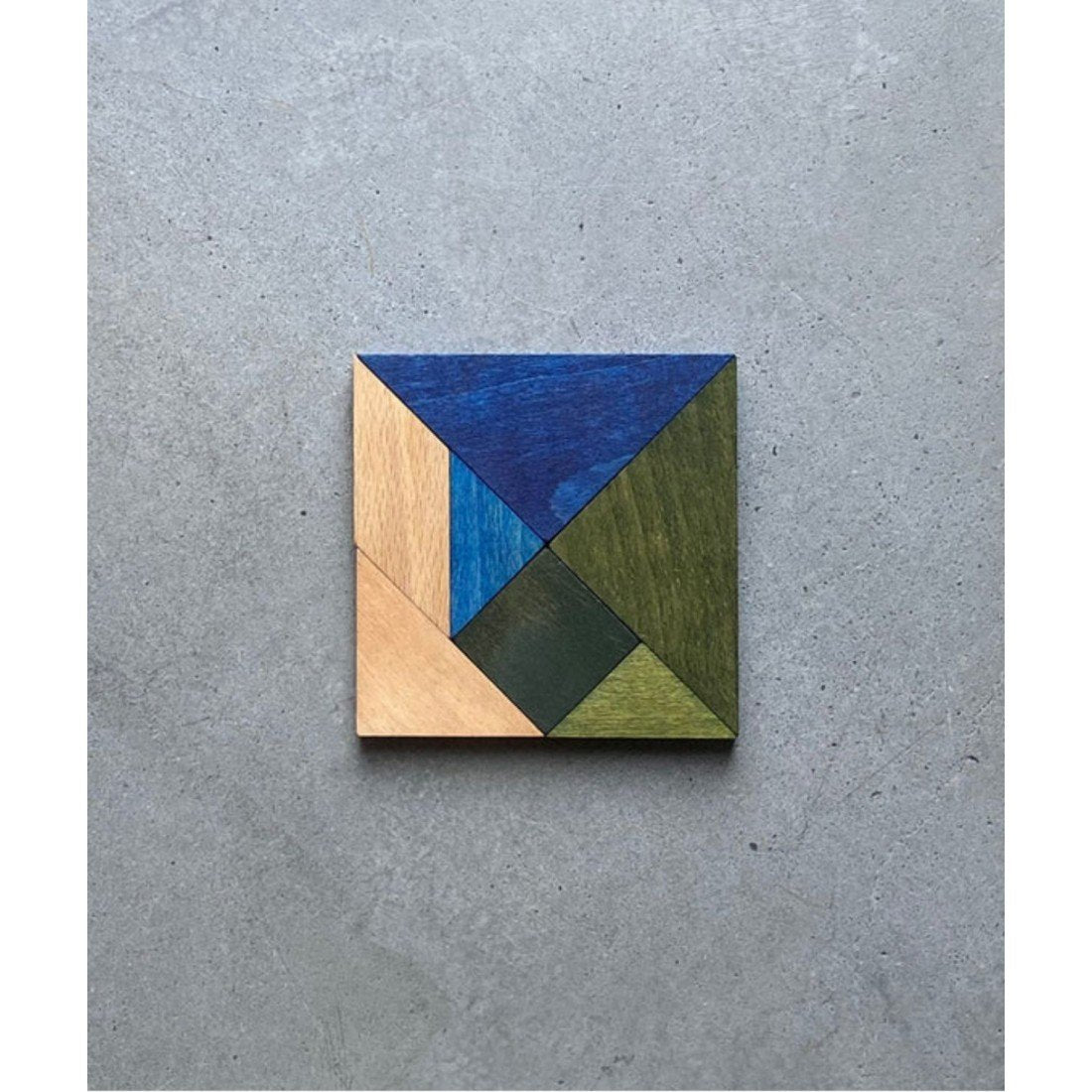 4. Wooden Story tangram set in cold colors arranged in a square on a grey background